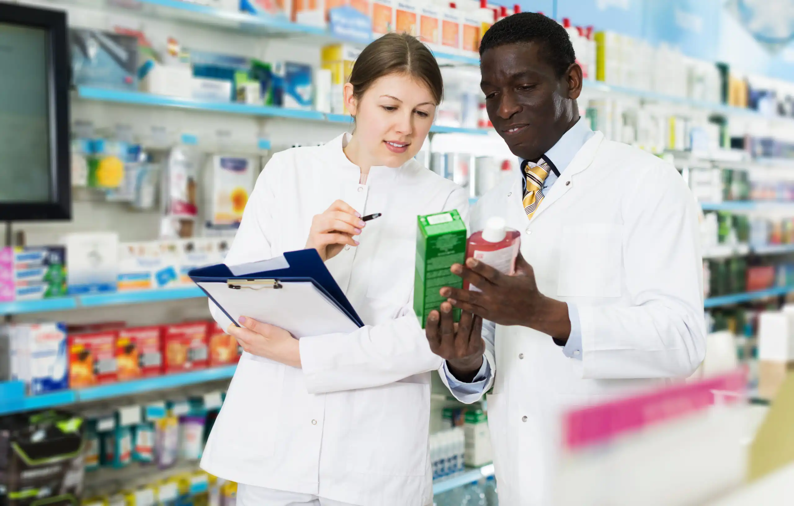 pharmacists taking inventory of medicines in pharmacy